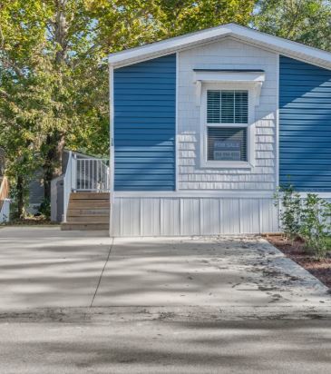 Blue mobile home with driveway